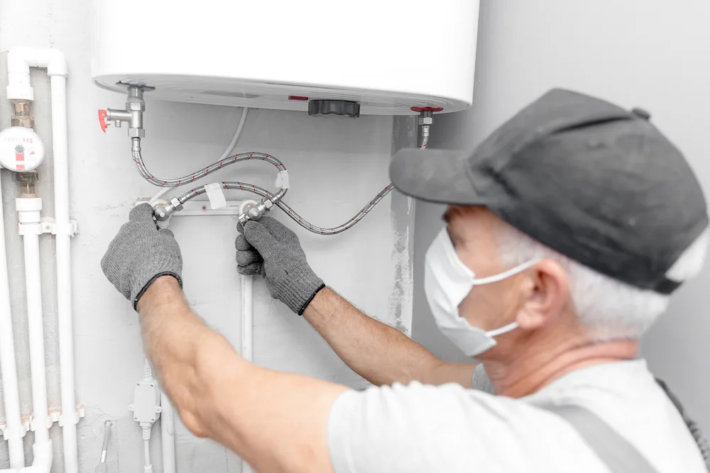 Photo of a Man Installing a Boiler